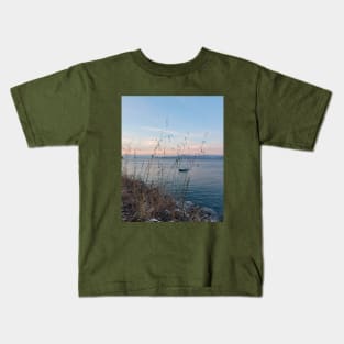 Serene Ocean Sunset: Boat Amidst Weeds Kids T-Shirt